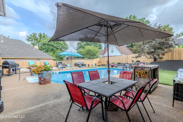 view of patio with a grill and a fenced in pool