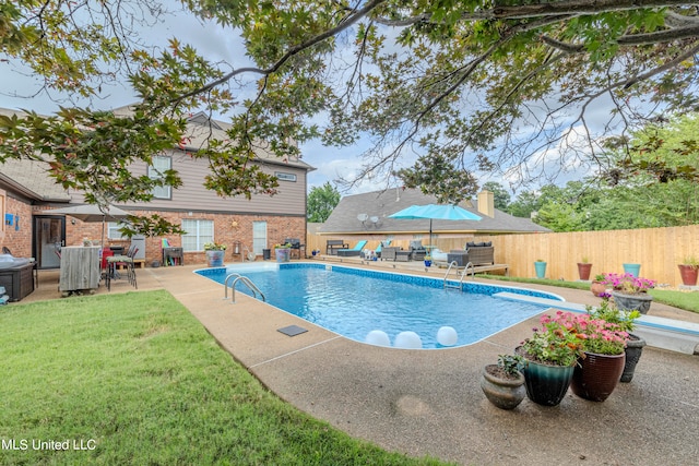 view of pool featuring a patio, a lawn, and a diving board