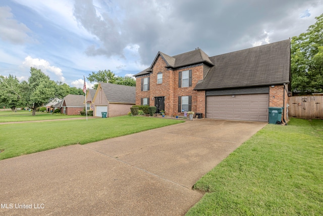 view of front of home featuring a front lawn and a garage