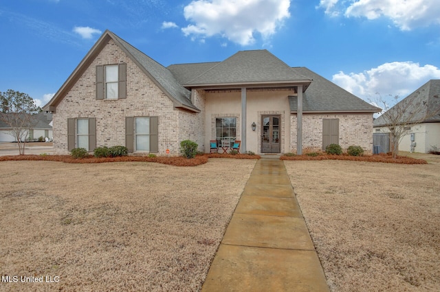 103 Sweetbriar Cir, Canton, MS 39046 - view of front of house with brick siding, roof with shingles, and french doors