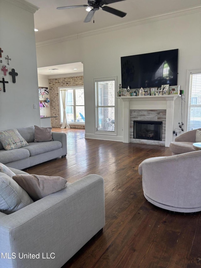 103 Sweetbriar Cir, Canton, MS 39046 - living room with crown molding, wood finished floors, a high end fireplace, a ceiling fan, and plenty of natural light