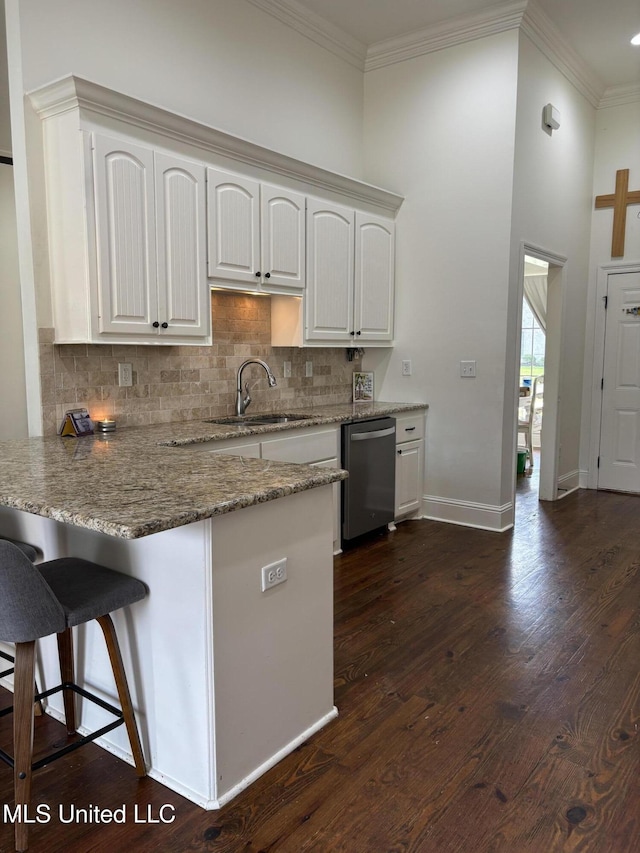 103 Sweetbriar Cir, Canton, MS 39046 - kitchen featuring a sink, stainless steel dishwasher, white cabinetry, ornamental molding, and a peninsula