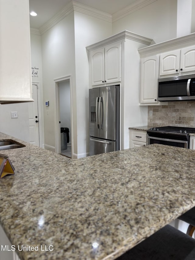 103 Sweetbriar Cir, Canton, MS 39046 - kitchen with appliances with stainless steel finishes, backsplash, light stone countertops, crown molding, and recessed lighting