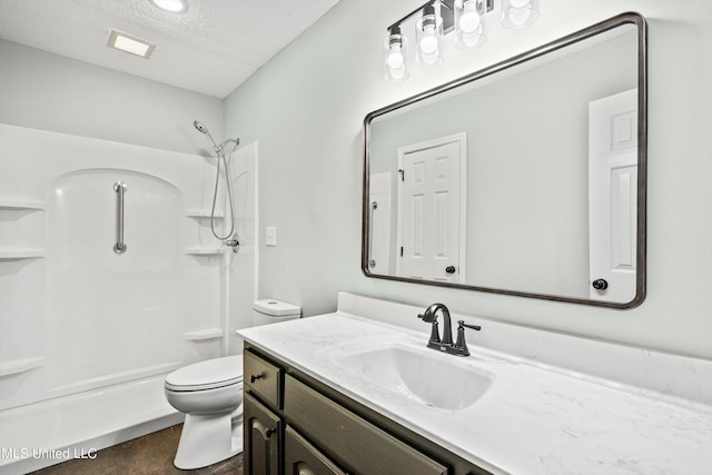 bathroom with toilet, a textured ceiling, and vanity