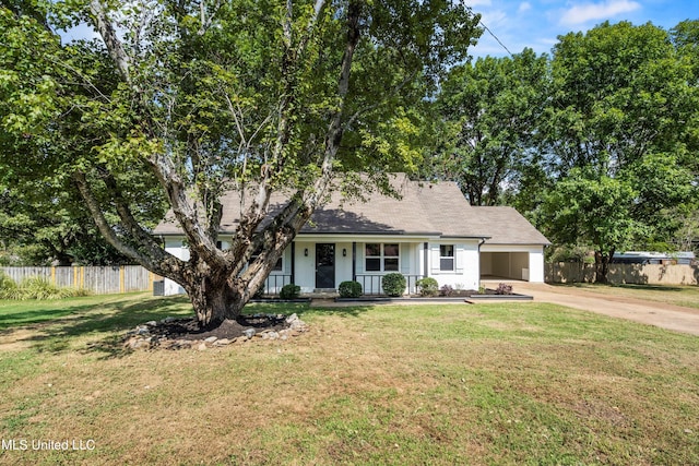 view of front facade with a porch, a front yard, and a garage