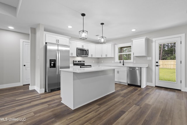 1457 Rue De Courmont, Gautier, MS 39553 - kitchen featuring appliances with stainless steel finishes, recessed lighting, dark wood-style floors, white cabinets, and light countertops