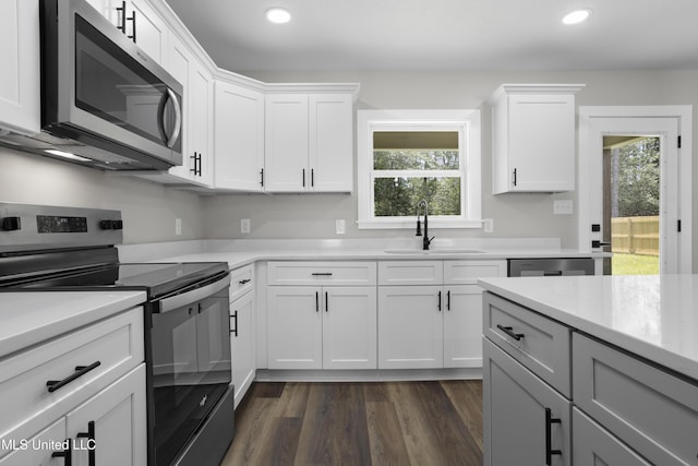 1457 Rue De Courmont, Gautier, MS 39553 - kitchen with appliances with stainless steel finishes, recessed lighting, light countertops, plenty of natural light, and dark wood-style floors