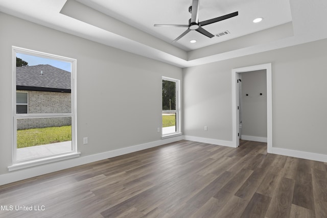 1457 Rue De Courmont, Gautier, MS 39553 - empty room featuring a raised ceiling, a ceiling fan, wood finished floors, and recessed lighting