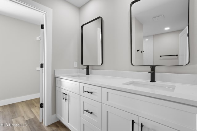 1457 Rue De Courmont, Gautier, MS 39553 - bathroom with double vanity, wood finished floors, and recessed lighting