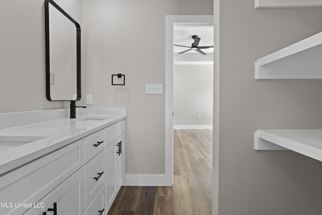 1457 Rue De Courmont, Gautier, MS 39553 - bathroom featuring ceiling fan, wood finished floors, and double vanity