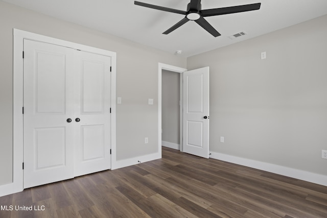 1457 Rue De Courmont, Gautier, MS 39553 - unfurnished bedroom featuring dark wood finished floors, a closet, and ceiling fan