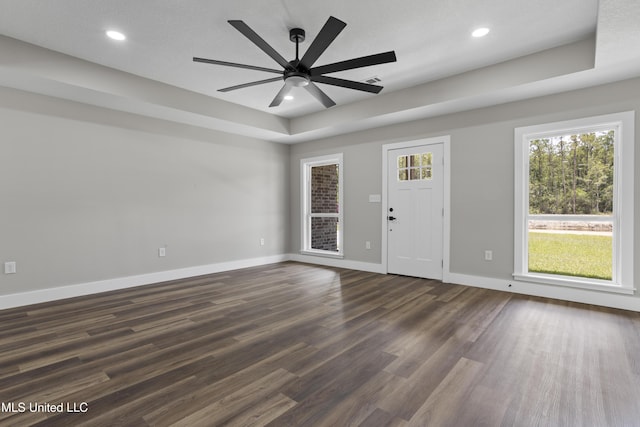 1457 Rue De Courmont, Gautier, MS 39553 - foyer featuring a ceiling fan, dark wood-style flooring, recessed lighting, and a raised ceiling