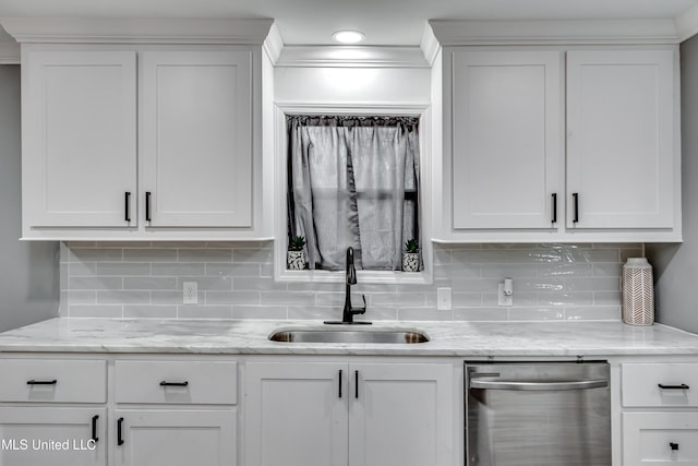 kitchen with white cabinetry, sink, and backsplash