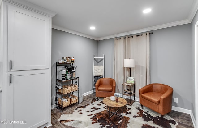 living area with ornamental molding and dark hardwood / wood-style floors