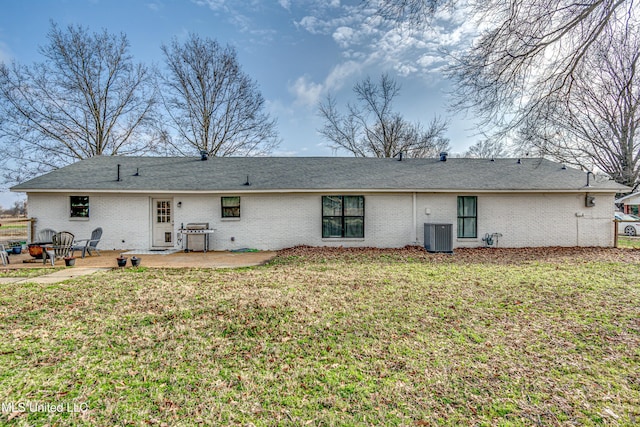 back of property featuring central AC unit, a yard, and a patio area