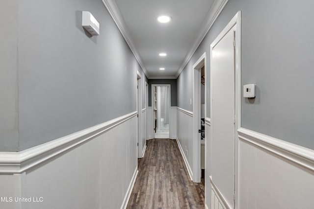 hallway featuring crown molding and dark hardwood / wood-style flooring