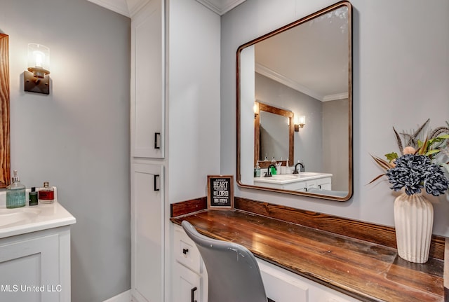 bathroom featuring ornamental molding and vanity