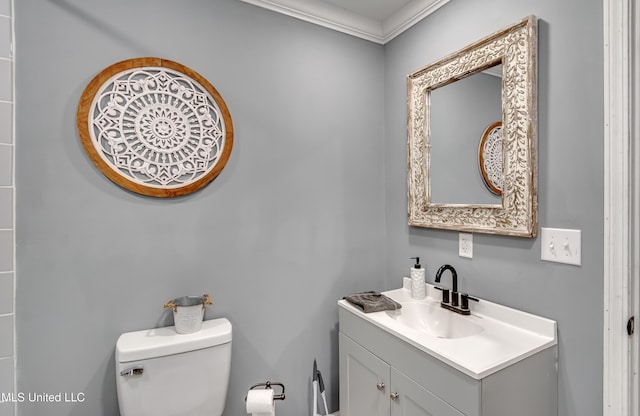 bathroom with vanity, ornamental molding, and toilet