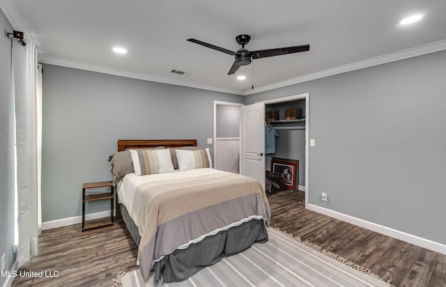 bedroom featuring dark wood-type flooring, ceiling fan, and crown molding