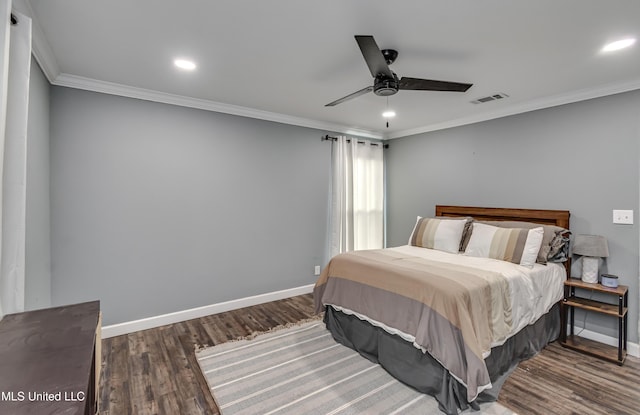 bedroom with crown molding, dark wood-type flooring, and ceiling fan