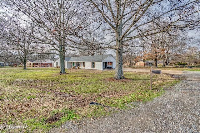 ranch-style home with a front yard