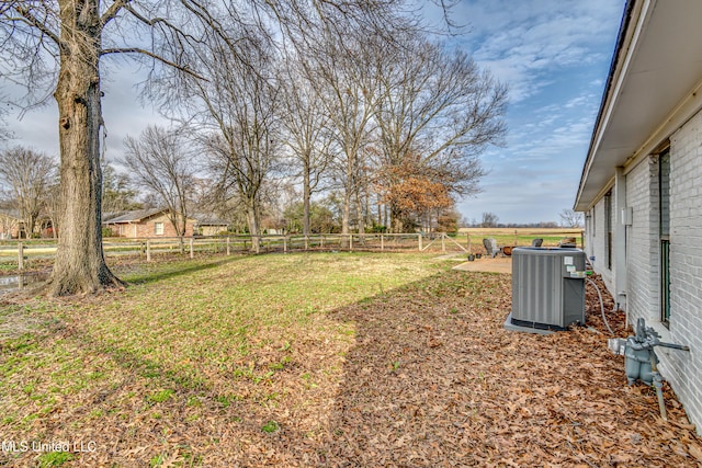 view of yard featuring central AC unit and a rural view