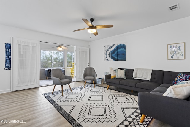 living room with hardwood / wood-style floors and ceiling fan