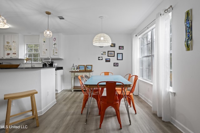 dining room featuring sink and light hardwood / wood-style flooring