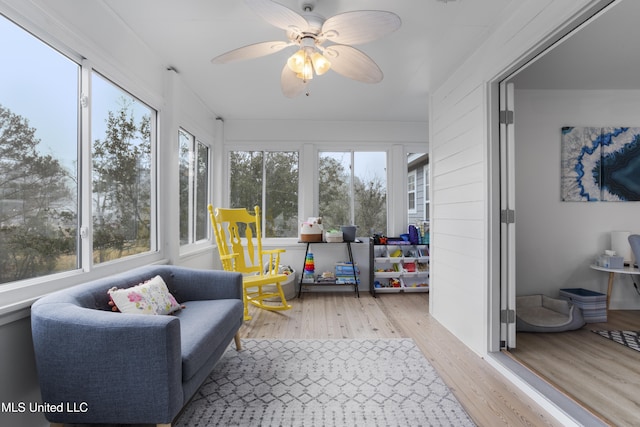 sunroom featuring ceiling fan