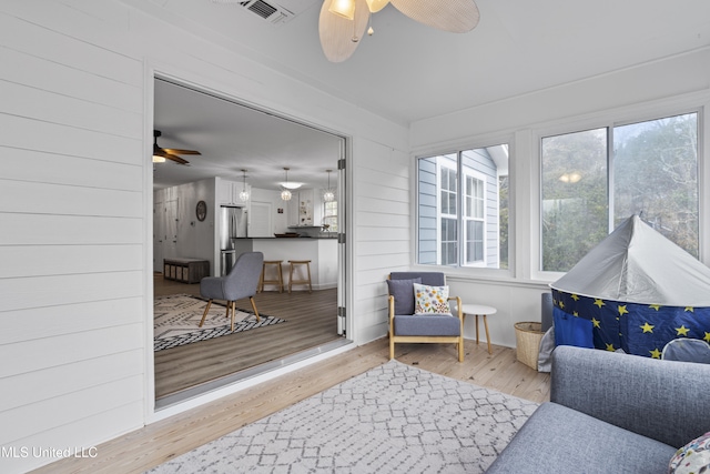 sunroom / solarium with ceiling fan