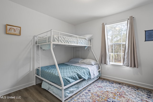 bedroom with wood-type flooring and multiple windows