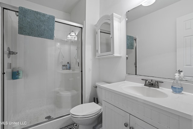 bathroom featuring vanity, toilet, and a shower with door