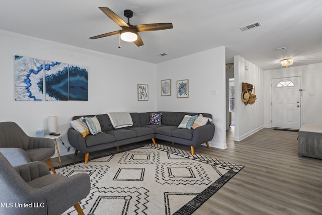 living room with wood-type flooring and ceiling fan