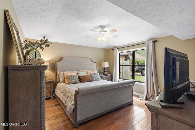 bedroom featuring ceiling fan, a textured ceiling, and hardwood / wood-style floors