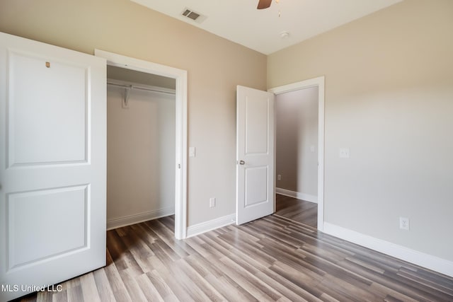 113 Magnolia Farms Dr, Lucedale, MS 39452 - unfurnished bedroom with wood finished floors, a closet, baseboards, and ceiling fan