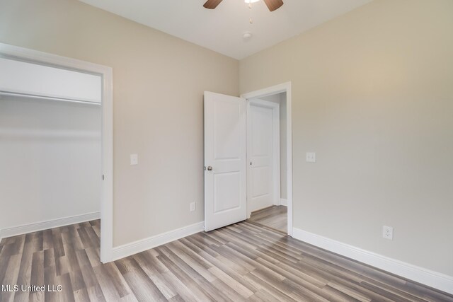 113 Magnolia Farms Dr, Lucedale, MS 39452 - unfurnished bedroom with wood finished floors, baseboards, a closet, and ceiling fan