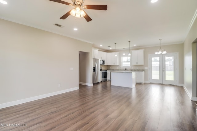 113 Magnolia Farms Dr, Lucedale, MS 39452 - unfurnished living room featuring crown molding, recessed lighting, a chandelier, wood finished floors, and ceiling fan