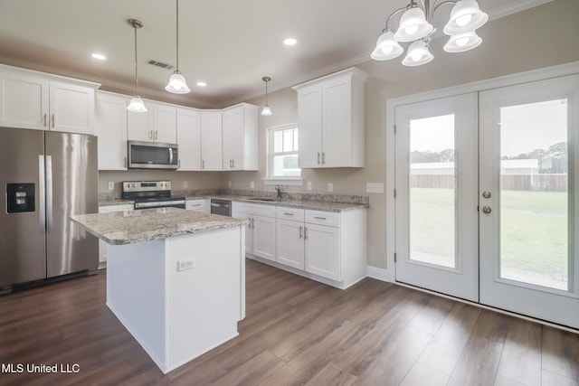 113 Magnolia Farms Dr, Lucedale, MS 39452 - kitchen featuring appliances with stainless steel finishes, french doors, white cabinets, a kitchen island, and crown molding