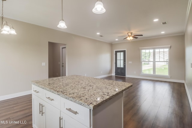 113 Magnolia Farms Dr, Lucedale, MS 39452 - kitchen featuring dark wood-style flooring, a kitchen island, a ceiling fan, decorative light fixtures, and ornamental molding