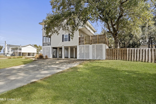 view of front facade with a front lawn and a carport