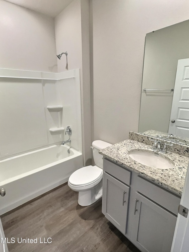 full bathroom featuring shower / bath combination, vanity, toilet, and wood finished floors