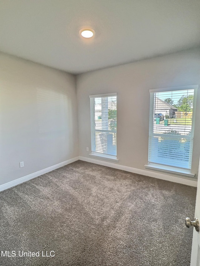 spare room with carpet floors and baseboards