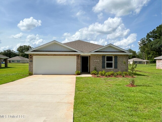 ranch-style house featuring a front yard and a garage