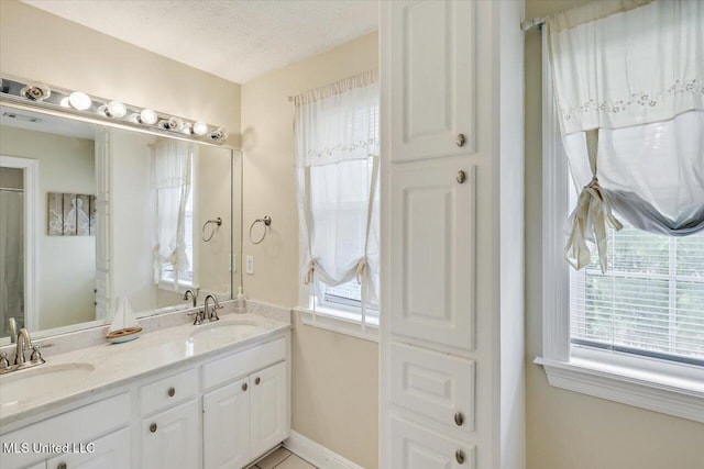 501 Brighton Cir, Brandon, MS 39047 - bathroom with double vanity, baseboards, and a textured ceiling
