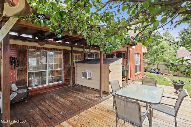 501 Brighton Cir, Brandon, MS 39047 - wooden deck with a ceiling fan, fence, outdoor dining space, a wall unit AC, and a storage unit