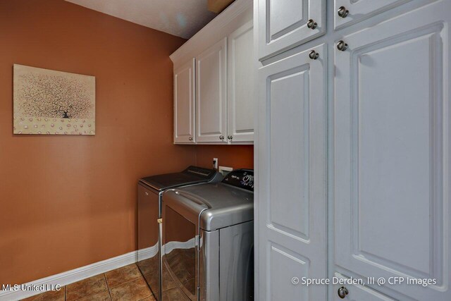 501 Brighton Cir, Brandon, MS 39047 - washroom with cabinet space, baseboards, washer and clothes dryer, and dark tile patterned floors