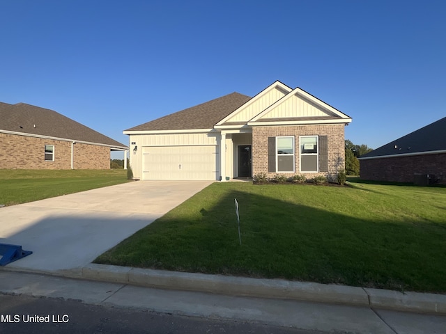 view of front of house with a front yard and a garage