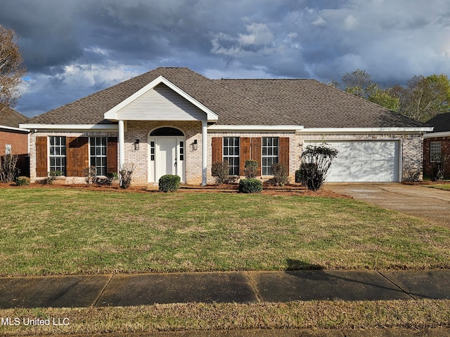 ranch-style house featuring a garage and a front yard