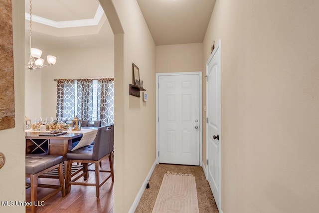 entryway featuring arched walkways, baseboards, and a chandelier