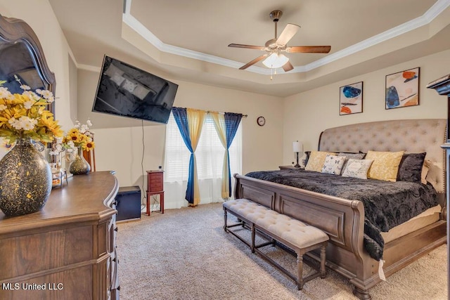 carpeted bedroom featuring crown molding, a raised ceiling, and a ceiling fan